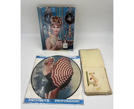 A Marilyn Monroe LP picture disc, an early 20thC autograph book and a Martell advertisement.