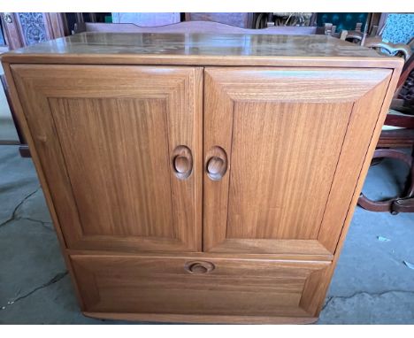 Ercol television cabinet with pull out shelf to base. 