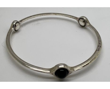 A Georg Jensen sterling silver sphere bangle 473 set with black onyx. Interior measurement 6.5gm. 
