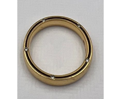 A 18 carat yellow gold Damiani wedding band set with diamonds to both sides. Size Q/R. Weight 6.2gm. 