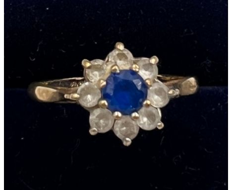 A 9 carat gold ring set with blue and clear paste stones. Size K. Weight 1.8gm. 