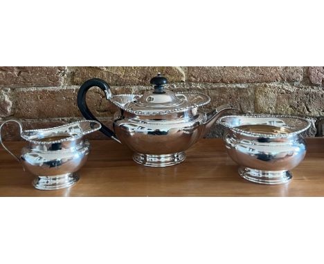 A three piece silver tea-service with ebony knop and handle, Sheffield 1908, maker Atkinson Brothers. Total weight 821gm. Ret