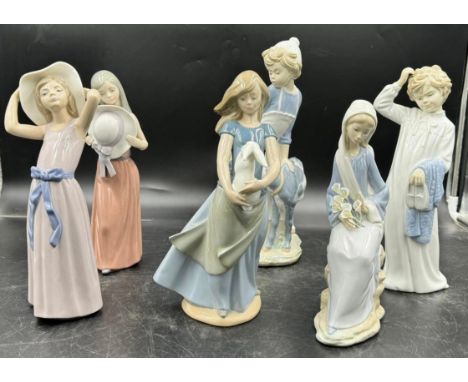 Three Nao by Lladro figurines to include girl with a goat approx. 30cm h, girl with a rabbit approx. 27cm h, bedtime boy appr