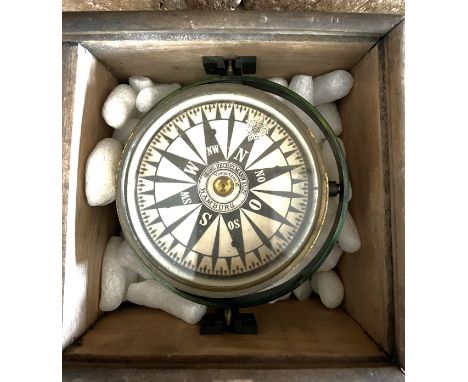A gamble mounted ships compass in wood outer case, lacking lid. Case 18cm x 18cm. Maker Georg Hechelmann Hamburg. 