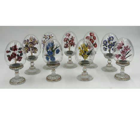 Nine Franklin Mint House of Fabergé clear glass pedestal eggs, each with an enamel floral spray with simulated pearls, engrav