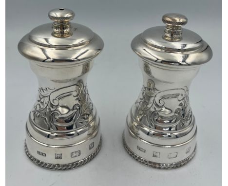 A boxed hallmarked silver salt and pepper grinder. Grinder marked Peugeot to mechanism. Birmingham 1985, maker Laurence R Wat