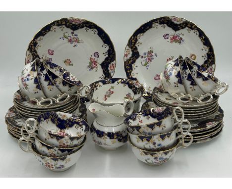 English Diamond China porcelain part tea service decorated with hand painted sprays of flowers with cobalt blue and gilt bord