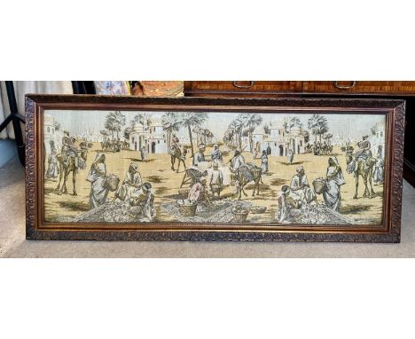 A large early 19thC machine made tapestry-style picture of a Middle Eastern market/street scene in a vintage wooden frame. Vi