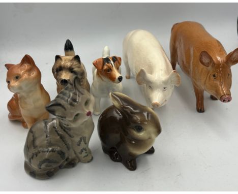 A collection of ceramic animals to include Beswick Jack Russell dog, Wallqueen pig, cat, Doulton pig, cat and Goebel rabbit. 