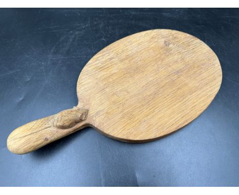 Robert Thompson 'Mouseman' of Kilburn, an adzed oak cheese board of oval form with a carved mouse signature to the base of th
