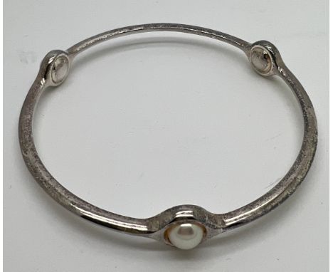 A Georg Jensen 473 sterling silver and pearl bangle. Interior measurement 6.5cm approximately. 