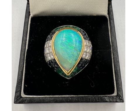 An opal, diamond, sapphire and emerald ring set in 18 carat white and yellow gold. Size M. Weight 13.5gm. 