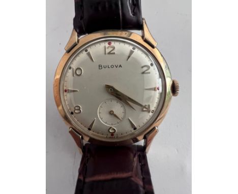 A 1956 manual 10k gold plated Bulova NY Executive Retro Curvex wristwatch with subsidiary seconds dial on brown leather strap