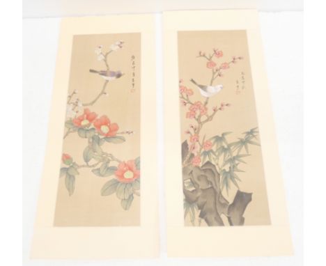 A pair of Chinese paintings on silk depicting birds sat on cherry blossom branch, and books on Chinese calligraphy