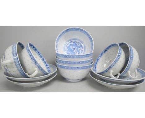 A large collection of Chinese blue and white bowls, cups and saucers (approximately 22 cups). Each with dragon design to cent