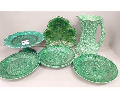 Seven items of Wedgwood green leafware, four plates, a pair of dishes and a comport and a Sylvac vase/jug