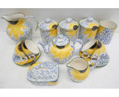 A collection of Poole pottery with yellow flower detail 