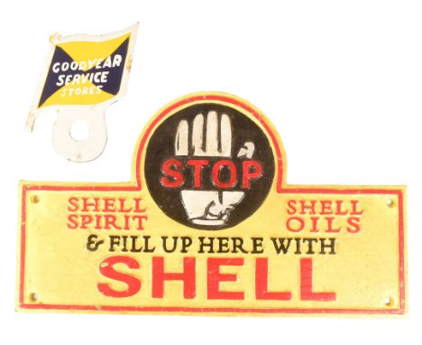 A vintage cast iron Shell Petrol garage advertising sign together with a smaller Goodyear Service Stores enamel sign. The lar
