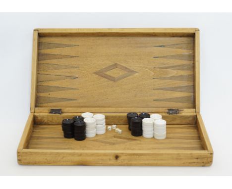 A vintage Cypriot wooden backgammon game with inlaid design, with two sets of stones and dice.