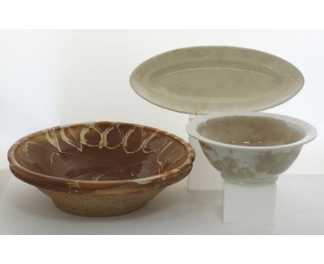 A large ceramic bowl glazed inside with white linear decoration W48cm, H13.5cm together with a white ceramic bowl diam.32cm, 