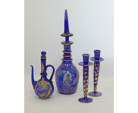 A collection of Bohemian blue glass decanters and candleholders made for the Persian Market. The tall decanter H51cm with a p