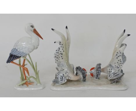 Two Rosenthal porcelain figurines, one with a stork or heron H13cm by artist Fritz Heidenreich and one with two roosters figh