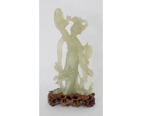 A Chinese carved celadon jade figure, H21cm, modelled as a lady, attached on a carved hardwood base, mid to late 20th century