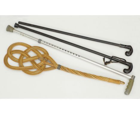 Three walking sticks comprising an adjustable aluminium and two wooden, together with a vintage woven Rattan Rug Beater. The 
