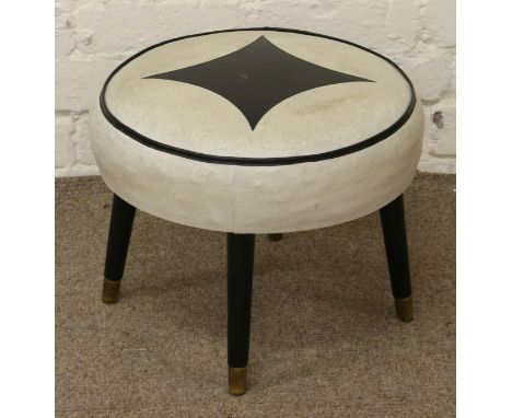 A 1960s leatherette pouffe raised on turned and painted legs.