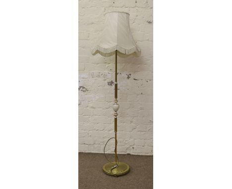 A brass effect and onyx standard lamp and shade.