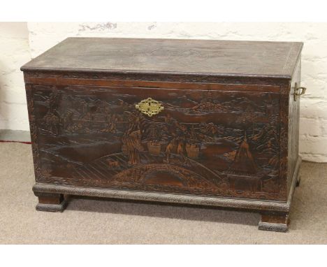 An extensively carved eastern camphor wood chest raised on pad feet. Condition Report. To be used as a guide only. One piece 
