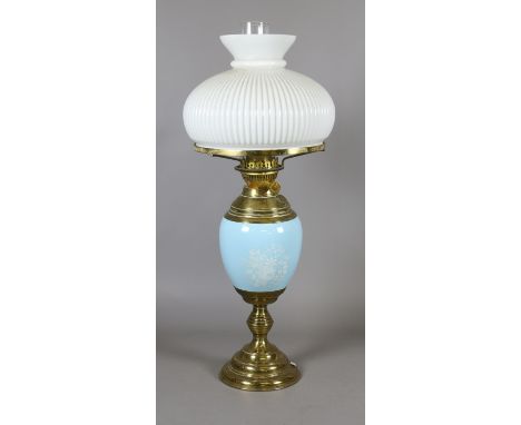 A Duplex brass based oil lamp with milk glass shade.