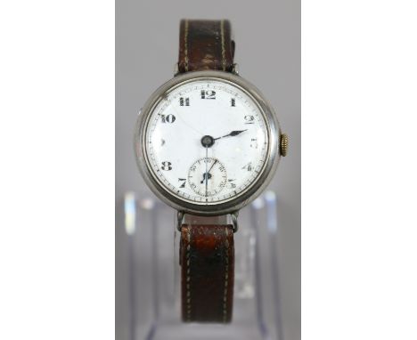 A gents silver cased manual trench watch with white enamel dial and second subsidiary dial.