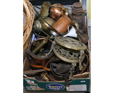 A box of copper and brass metalwares to include jam pan, cook pots, trivets, flat irons, old storm lantern etc.