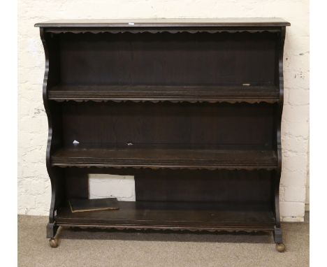 A carved mahogany four shelf open bookcase.