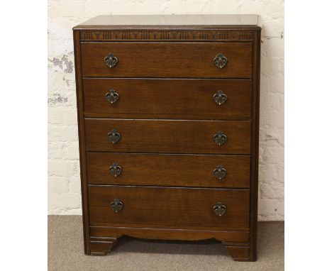 An oak chest of five drawers, raised on bracket feet.