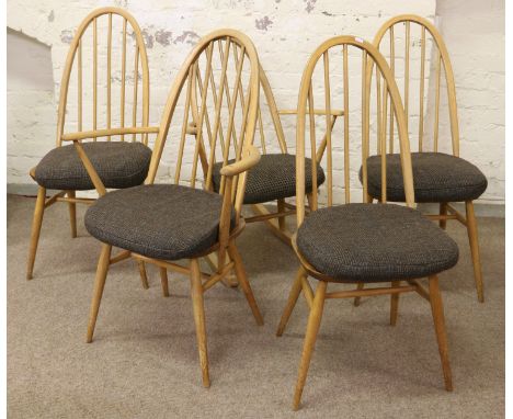 Three Ercol ash and elm spindle back chairs, a matching carver arm chair and rocking chair.