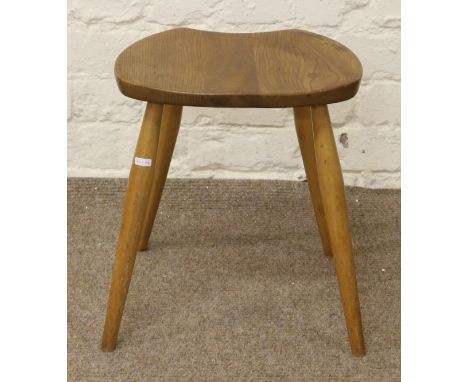 An Ercol Golden Dawn stool raised on tapering turned legs.
