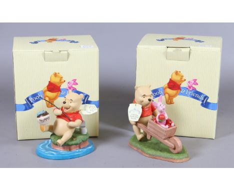 Two boxed ceramic Pooh Bear and Friends figurines 'Hip Hip Hooray the Catch of the Day' and 'Collecting Friends'.