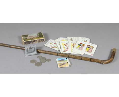 A gilt metal topped bamboo walking stick, a pack of vintage nursery rhyme themed playing cards, a 1977 Jubilee commemorative 