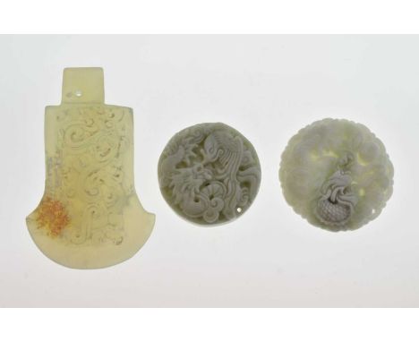 Three Chinese carvings, comprising two circular celadon jade 'bi' disc pendants, one with dragon, the other phoenix, 47mm dia