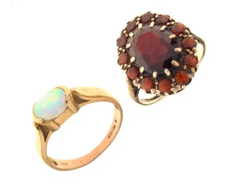 9ct gold ring set an opal cabochon, 6mm x 8mm approx, size O½ approx, and a 9ct gold garnet cluster ring, size M approx, 7.7g