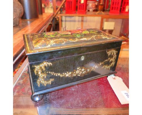 A fine quality 19th century papier mache tea caddy supported on four bun feet in the style of Jennings and Betridge