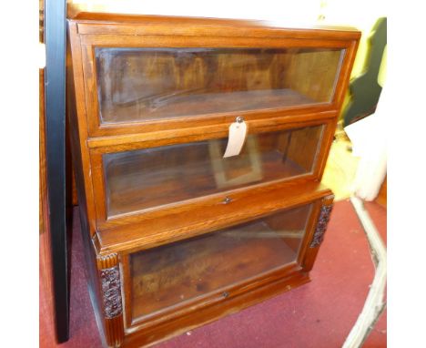 A Globe Wernicke style oak three tier bookcase having blazed panel doors