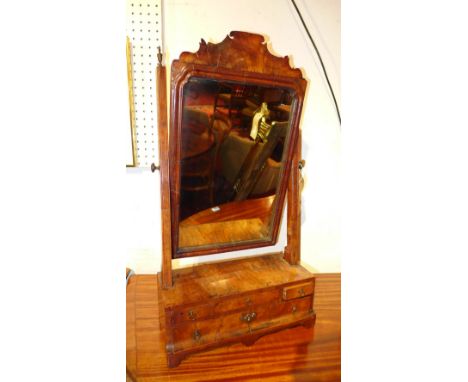 A Queen Anne style walnut toilet mirror, the bevelled rectangular plate within a crossbanded, moulded frame with fret carved 
