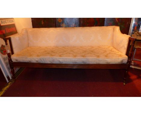 A 19th century mahogany sofa upholstered in ivory foliate damask raised on turned supports 