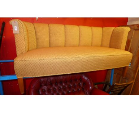 A contemporary designer two seater club sofa upholstered in orange patterned fabric 