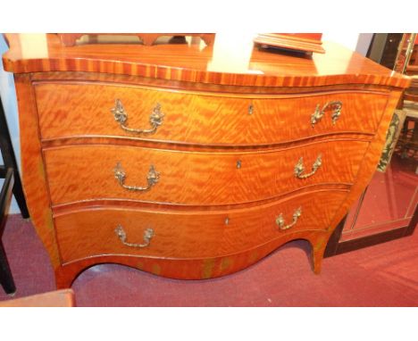 A 19th century satinwood commode chest with serpentine front features and original ornate swan neck handles H 82.5 x W 124 x 