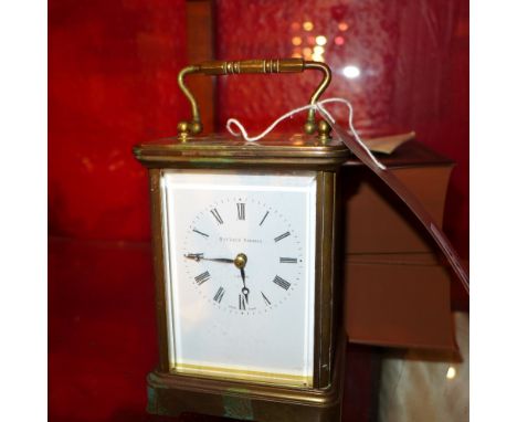 A Matthew Norman brass carriage clock with key, having four glazed bevelled sides, instructions and guarantee, originally pur