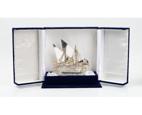A model of a twin masted sailing ship, detailed 800, having gilt highlights, raised on a marble base, height including base 2